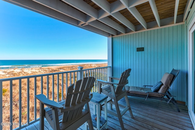 balcony with a beach view and a water view