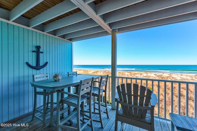 deck with a view of the beach and a water view