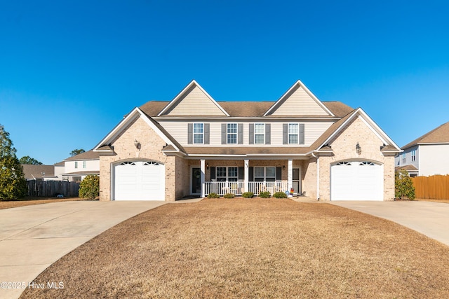 view of front of property featuring covered porch and a garage