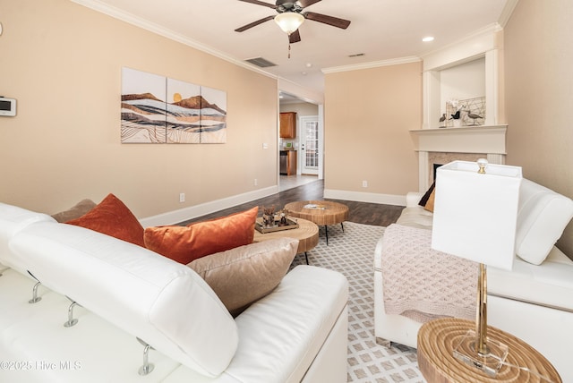 living room with ceiling fan, light wood-type flooring, crown molding, and a high end fireplace