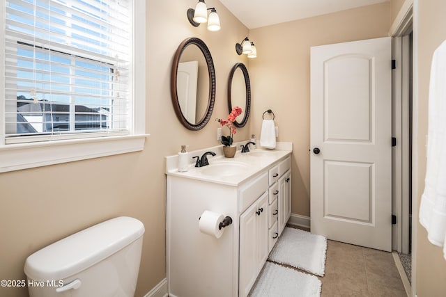 bathroom featuring tile patterned flooring, vanity, and toilet