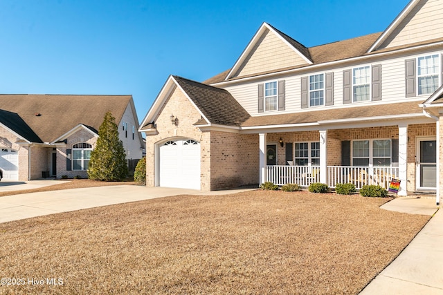 view of front of property with covered porch and a garage