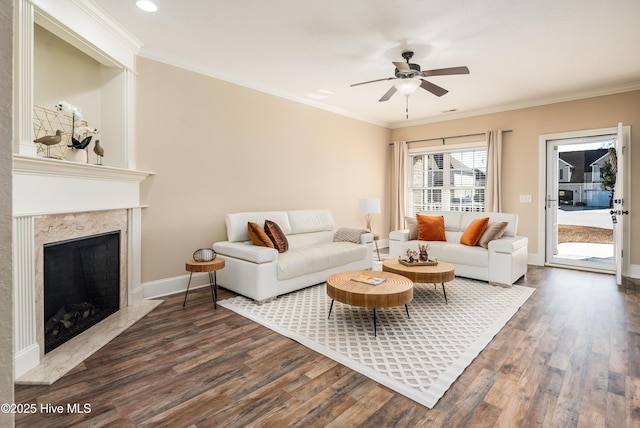 living room featuring crown molding, ceiling fan, dark hardwood / wood-style flooring, and a fireplace