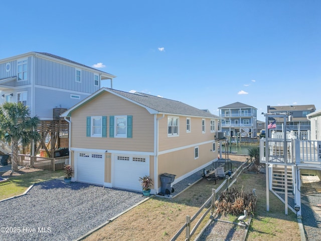 view of home's exterior featuring a garage and a water view