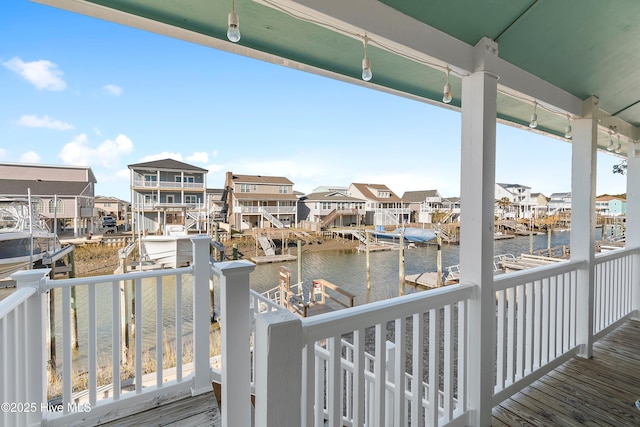 deck with a boat dock and a water view