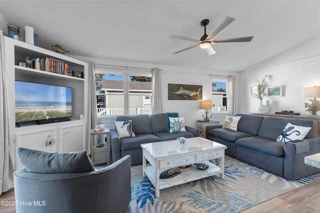 living room with hardwood / wood-style floors, vaulted ceiling, and ceiling fan