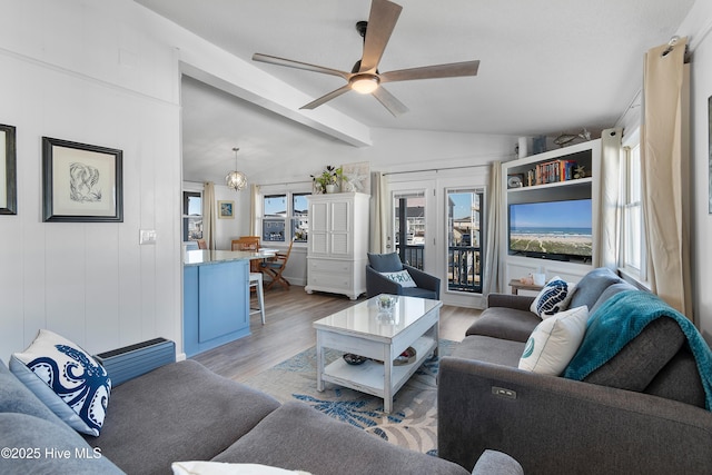 living room featuring vaulted ceiling with beams, ceiling fan, and light hardwood / wood-style floors