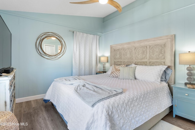 bedroom with ceiling fan, dark hardwood / wood-style flooring, and vaulted ceiling