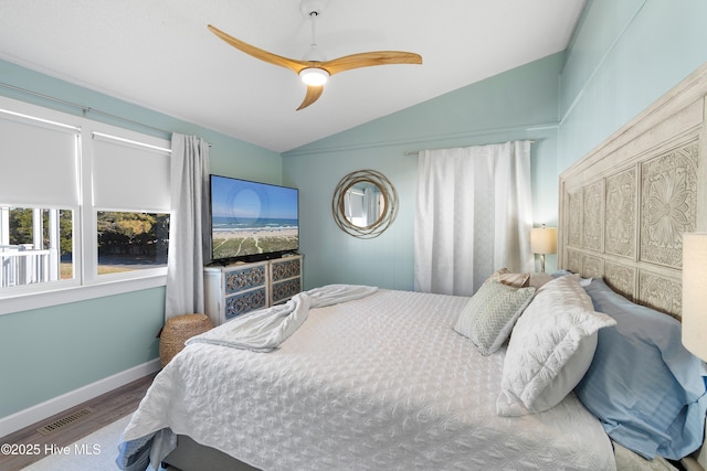 bedroom featuring ceiling fan, hardwood / wood-style floors, and vaulted ceiling