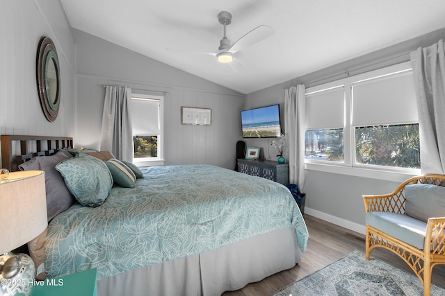 bedroom featuring ceiling fan, light hardwood / wood-style floors, and lofted ceiling