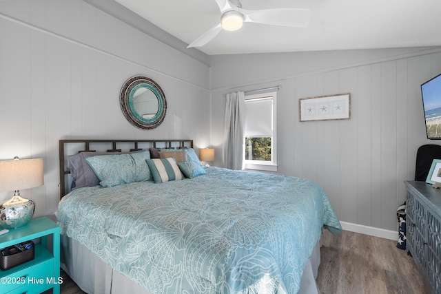 bedroom featuring hardwood / wood-style floors, vaulted ceiling, and ceiling fan