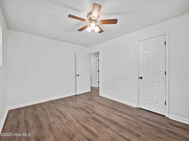 empty room featuring ceiling fan and dark hardwood / wood-style flooring