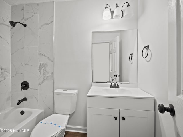 full bathroom with tiled shower / bath combo, vanity, and toilet