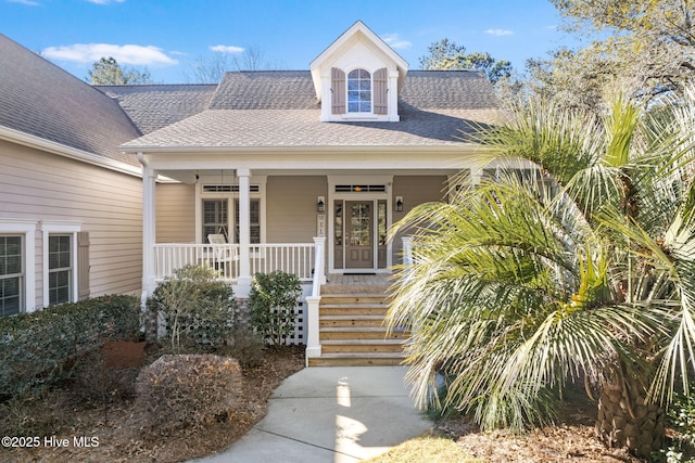 view of exterior entry with a porch