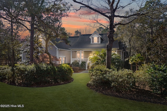 view of front of home featuring a porch and a lawn