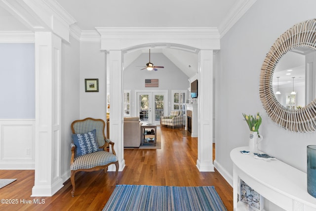 entryway with hardwood / wood-style floors, ornamental molding, decorative columns, and ceiling fan