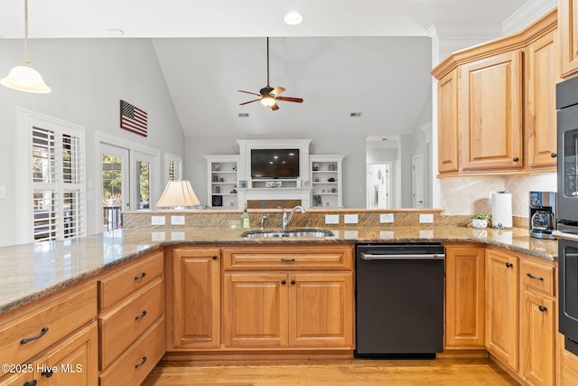 kitchen featuring sink, black dishwasher, light stone countertops, decorative light fixtures, and vaulted ceiling