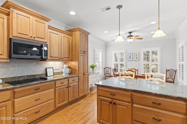552 Glenmora Ave SW, Supply, NC 28462 - kitchen featuring stainless steel microwave, black electric cooktop, light wood finished floors, crown molding, and ceiling fan