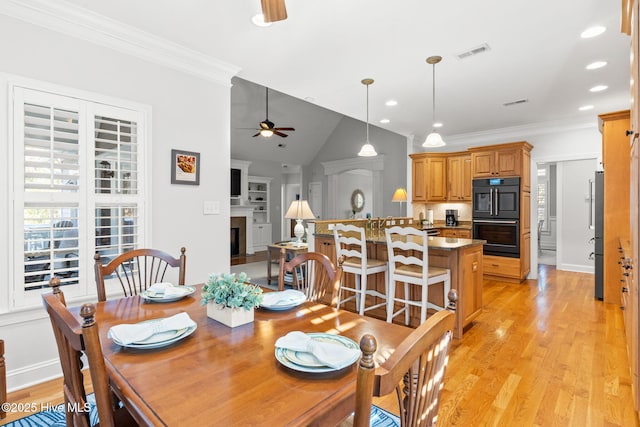 dining space featuring crown molding, ceiling fan, and light hardwood / wood-style floors