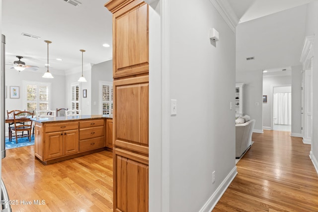 corridor with ornamental molding and light wood-type flooring