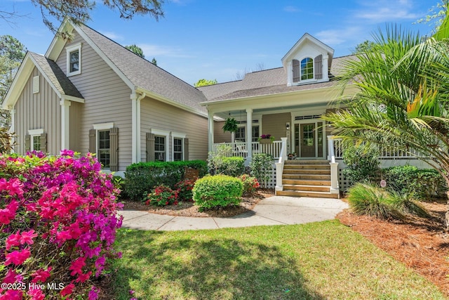 552 Glenmora Ave SW, Supply, NC 28462 - view of front facade featuring a porch, a shingled roof, a front yard, and board and batten siding