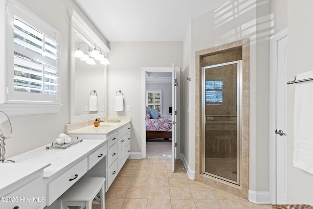 bathroom featuring tile patterned floors, plenty of natural light, a shower with door, and vanity