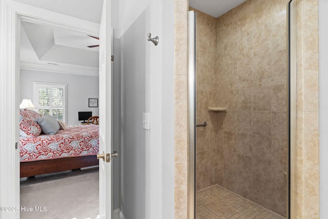 bathroom with a raised ceiling, crown molding, ceiling fan, and walk in shower