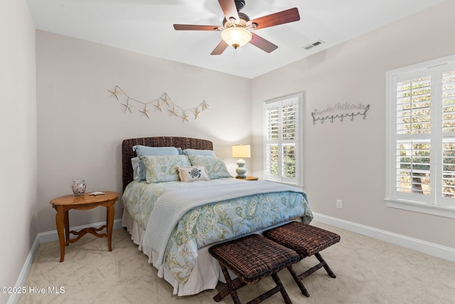 bedroom with light carpet and ceiling fan