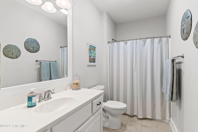 bathroom featuring vanity, tile patterned floors, and toilet