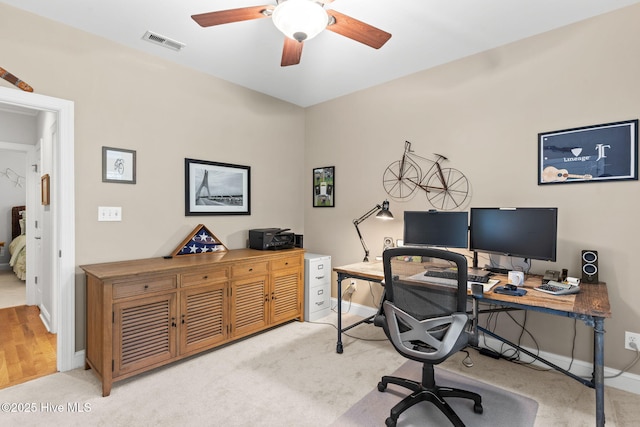 office space featuring light colored carpet and ceiling fan