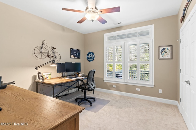 office space featuring light colored carpet and ceiling fan