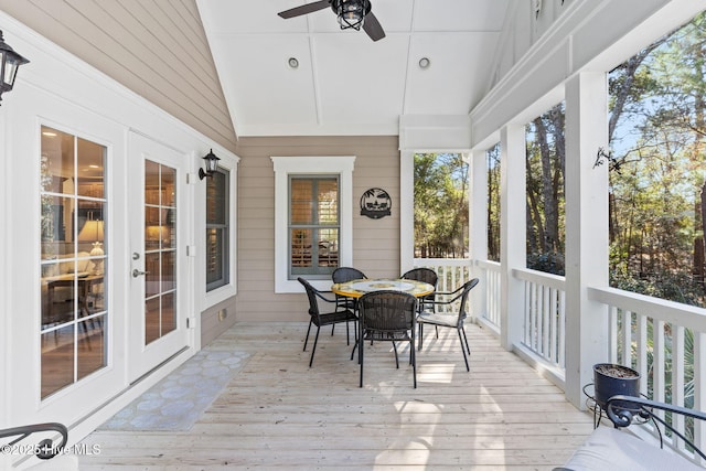 sunroom / solarium featuring lofted ceiling and ceiling fan