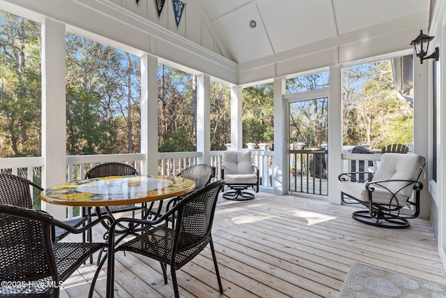 sunroom / solarium featuring vaulted ceiling