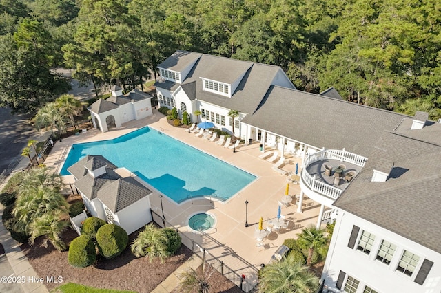 view of pool featuring a hot tub and a patio area