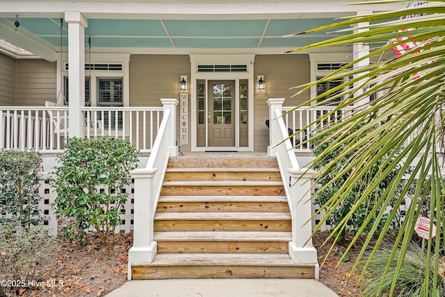 view of exterior entry featuring a porch