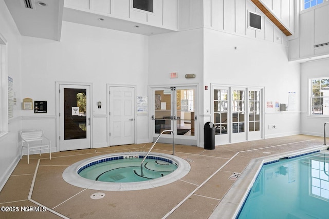 view of pool featuring french doors and an indoor hot tub