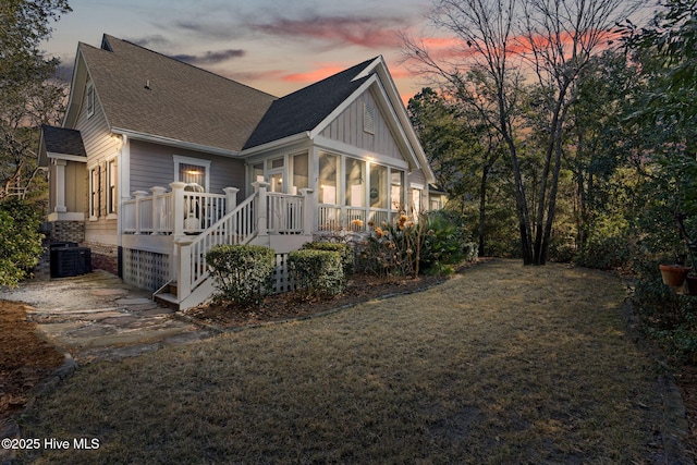 552 Glenmora Ave SW, Supply, NC 28462 - back of property featuring a sunroom, a shingled roof, board and batten siding, a deck, and cooling unit