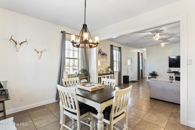 dining space featuring ceiling fan with notable chandelier and light tile patterned flooring