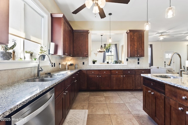 kitchen with sink, pendant lighting, dishwasher, and tasteful backsplash