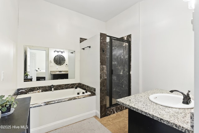 bathroom with vanity and independent shower and bath