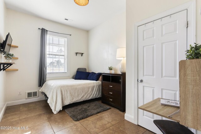 bedroom with light tile patterned floors