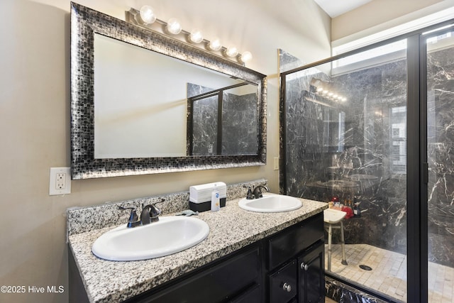 bathroom with a shower with door and vanity