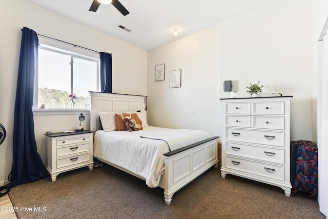 bedroom with ceiling fan and dark carpet