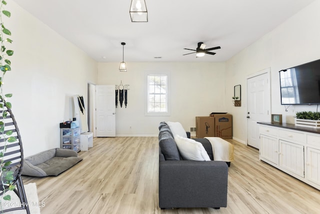 living room with ceiling fan and light hardwood / wood-style floors