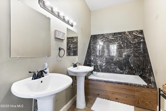 bathroom with a bathing tub and double sink