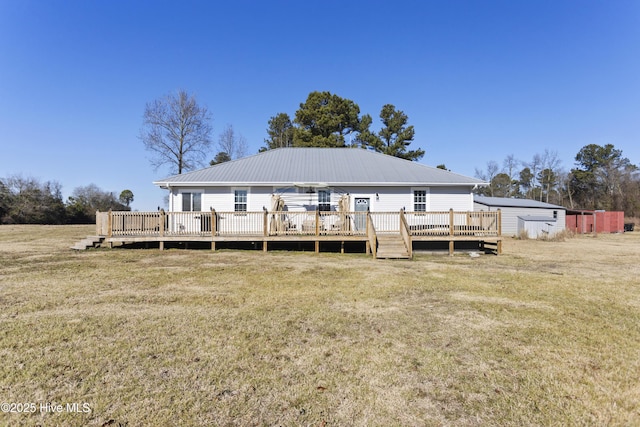 back of property with a deck and a yard