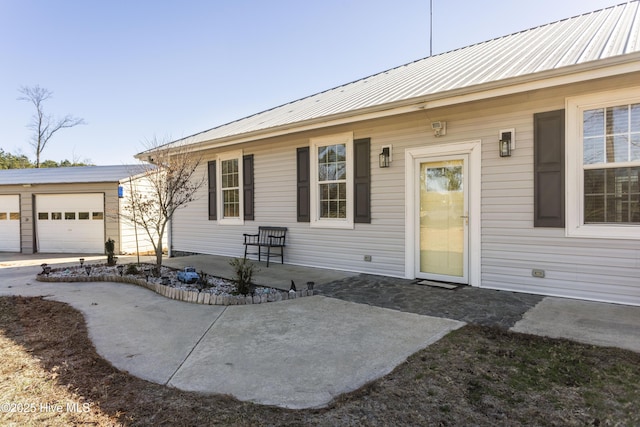 view of front of property with a patio area and a garage