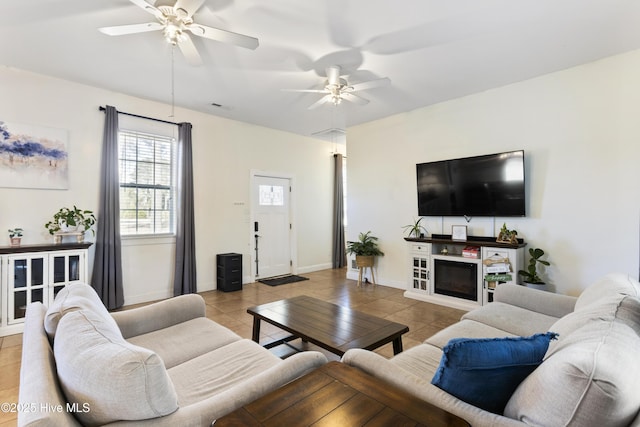 tiled living room with ceiling fan