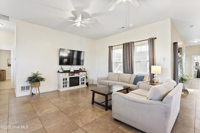 living room featuring ceiling fan and light tile patterned flooring