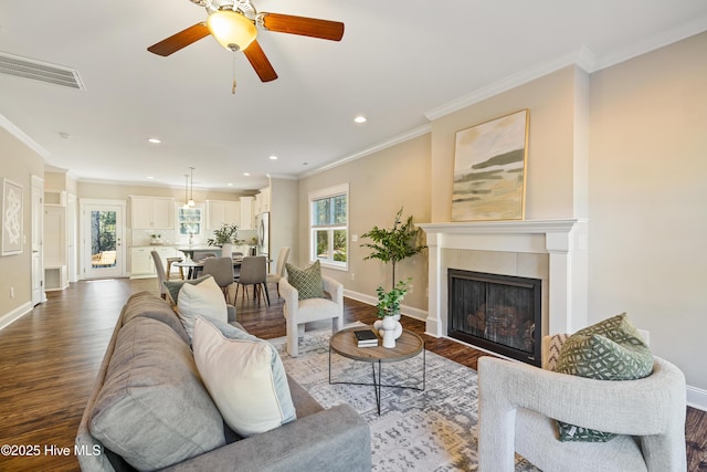 living room with ceiling fan, hardwood / wood-style flooring, and ornamental molding